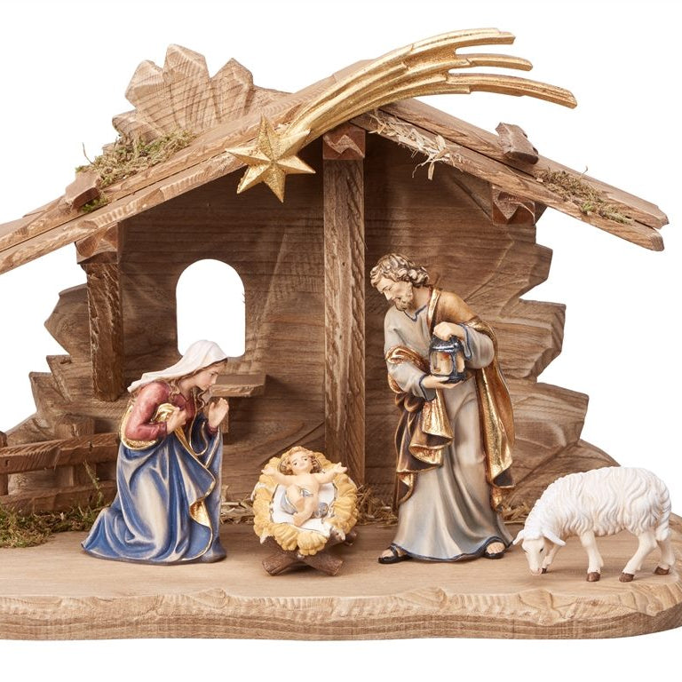 Nativity scene figurine with stable, Mary, Joseph, baby Jesus, and sheep on a white background